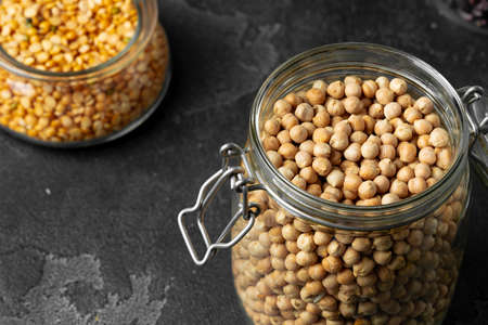 Uncooked dried chickpeas in glass jar close upの写真素材