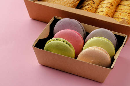 Pile of colorful macaroon cookies on pink backgroundの写真素材