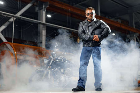 Portrait of motorbike rider in black leather outfitの写真素材