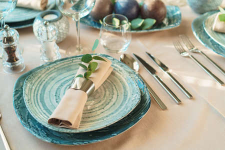 Luxury green table setting decorated with candles close upの写真素材