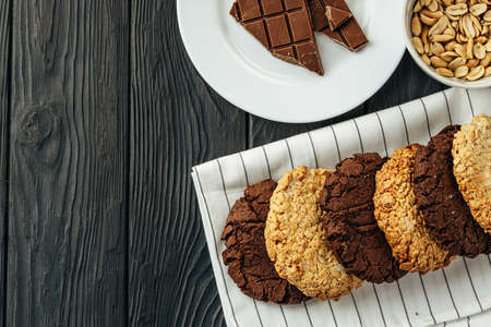 Chocolate and oat cookies on dark wooden table close upの写真素材