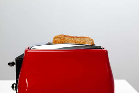 Couple of prepared toasts in a toaster, close upの写真素材