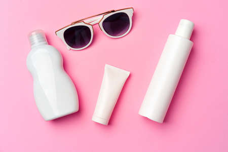 Sunglasses and sunblock cream close up on paper background with copy spaceの写真素材