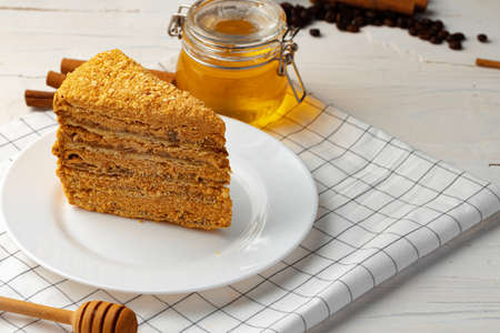 Slice of layered honey cake on plate