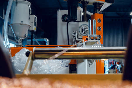 Inside a modern plant producing power electric cables and optical fibers. .Cable manufacturing machine part. Close up.の写真素材