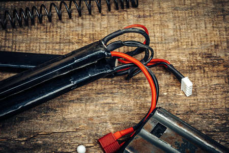 Rechargeable battery for airsoft rifle on wooden backgroundの写真素材