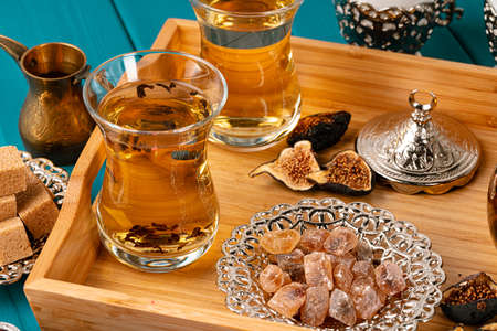 Turkish gllass cup of tea served with desserts on table, close upの写真素材