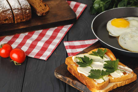 Simple breakfast. Toasted bread covered with butterclose up on wooden table