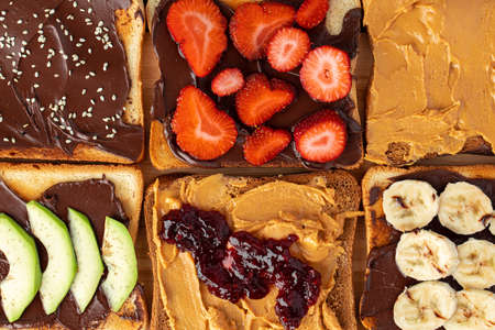 Assortment of sweet sandwiches with chocolate paste, peanut paste and fruit slices
