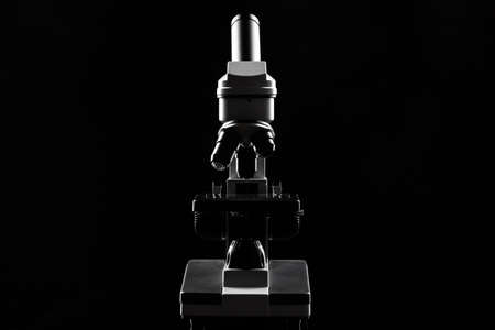 laboratory microscope on table in the dark