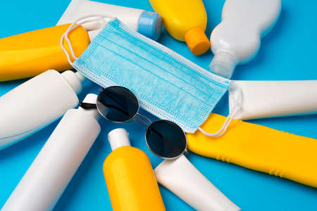 Sunscreen cream and protective mask. Coronavirus summer concept