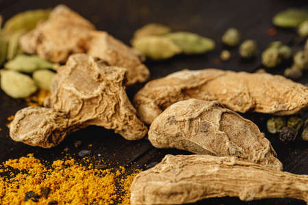 Dried ginger on dark wooden table close upの写真素材