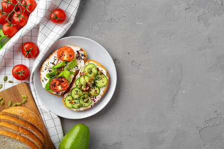 Vegan sandwiches with cheese feta, cucumber slices and cherry tomatoes. View from above
