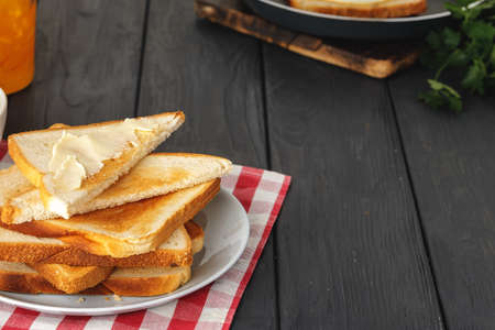 Simple breakfast. Toasted bread covered with butterの写真素材