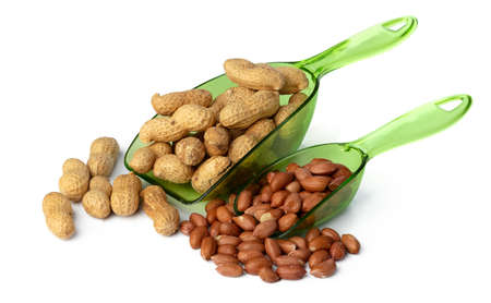 Spoon full with peanuts isolated on white background