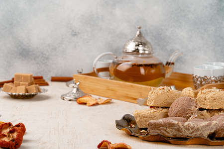 Turkish halva with tea in a glass cup close up on table