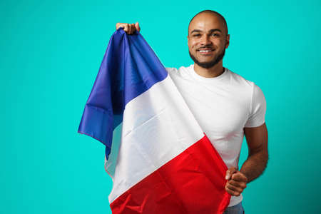 Mixed-race black man holding french flag close upの写真素材