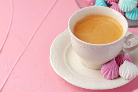 Cup of coffee with sweet colorful cookies close upの写真素材