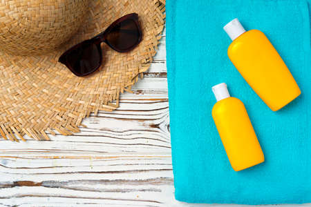Beach hat and sunscreen bottle. Vacation concept