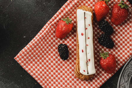 Eclair cake decorated with berries close up