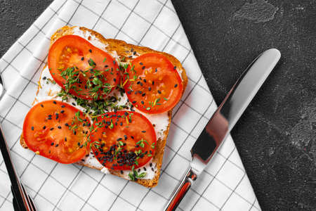 Sandwich with soft cheese and sliced tomatoes, top viewの写真素材