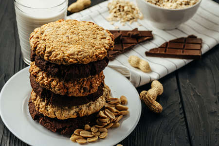 Chocolate and oat cookies on dark wooden table close upの写真素材