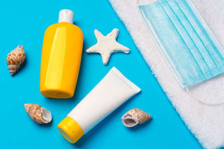 Sunscreen cream and protective mask. Coronavirus summer concept