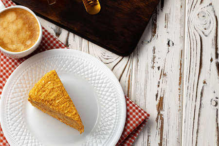 Slice of layered honey cake on plate