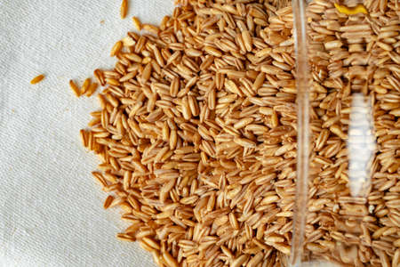 Bowl of uncooked whole oat grain close upの写真素材