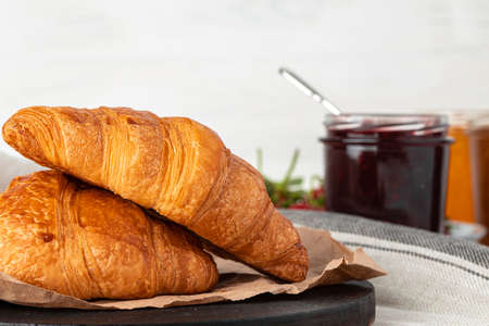 Fresh baked croissant on wooden table close upの写真素材