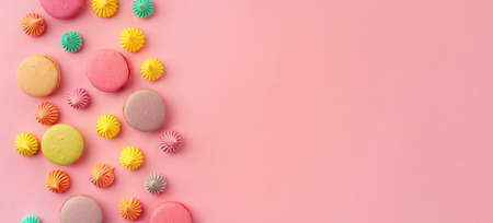 Pile of colorful macaroon cookies on pink backgroundの写真素材