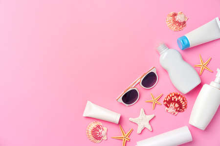 Sunglasses and sunblock cream close up on paper backgroundの写真素材