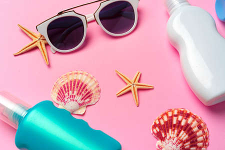 Sunglasses and sunblock cream close up on paper backgroundの写真素材