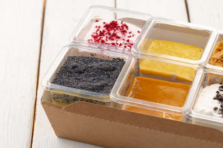Assortment of delicious dessert boxes on wooden table