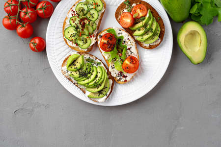 Assortment of vegan sandwiches with avocado and tomatoes