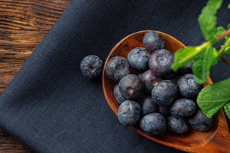 Bowl of fresh blueberry on kitchen table close upの写真素材