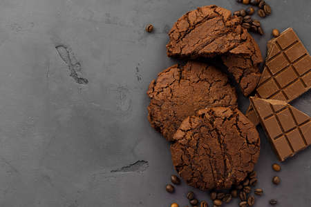 Chocolate oat cookies on dark surface with copy space