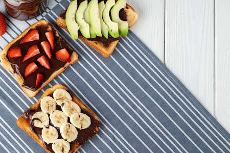 Assortment of sweet sandwiches with chocolate paste, peanut paste and fruit slices