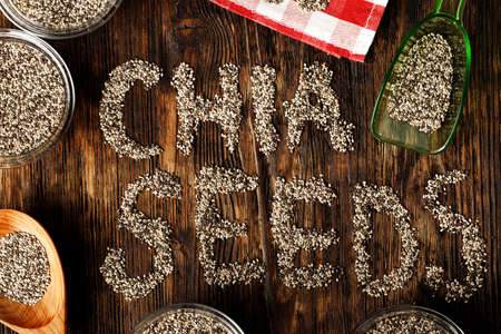 Chia seeds in green plastic scoop on tableの写真素材