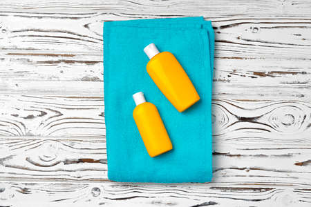Sunblock cream cosmetic bottles on wooden surfaceの写真素材