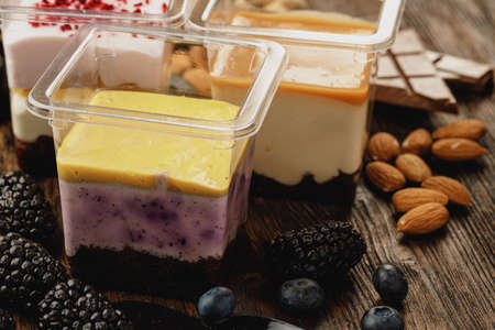 Assortment of delicious dessert boxes on wooden tableの写真素材