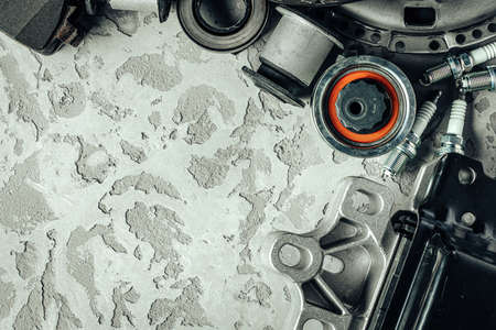 Car parts on grey textured concrete background