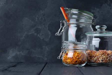 Glass jars with granola and muesli, front view