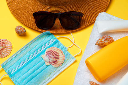 Sunscreen cream and protective mask. Coronavirus summer conceptの写真素材