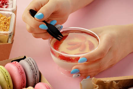 Female hands holding dessert in hands among fresh confectionary