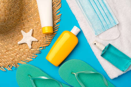 Sunscreen cream and protective mask. Coronavirus summer conceptの写真素材