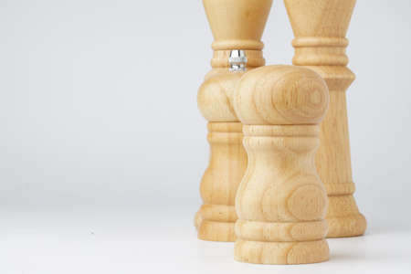 Wooden mills with salt and pepper on white