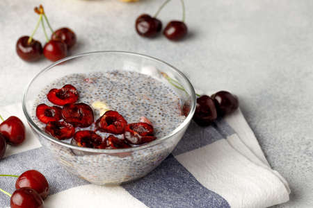 Chia pudding with cherry and nuts in glass bowlの写真素材