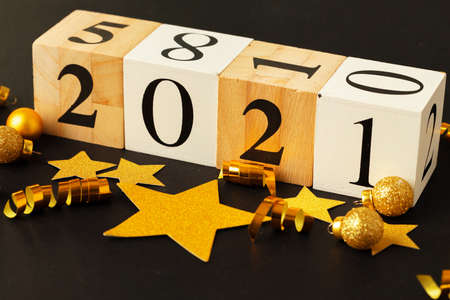 Concept of the year 2021. Golden stars with 2021 numbers on paper backgroundの写真素材