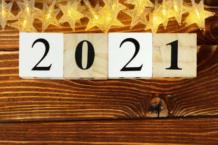 Concept of the year 2021. Golden stars with 2021 numbers on paper backgroundの写真素材
